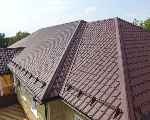 Brown metal tile roof with clean lines on residential home